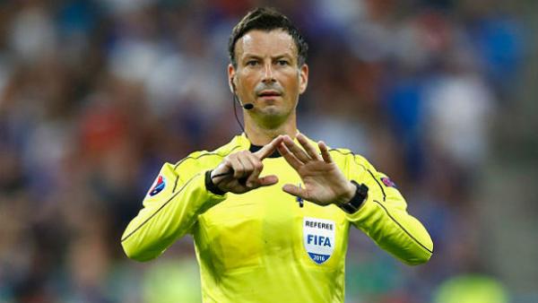FIFA referee Mark Clattenburg gestures for a football during the Euro 2016 final.