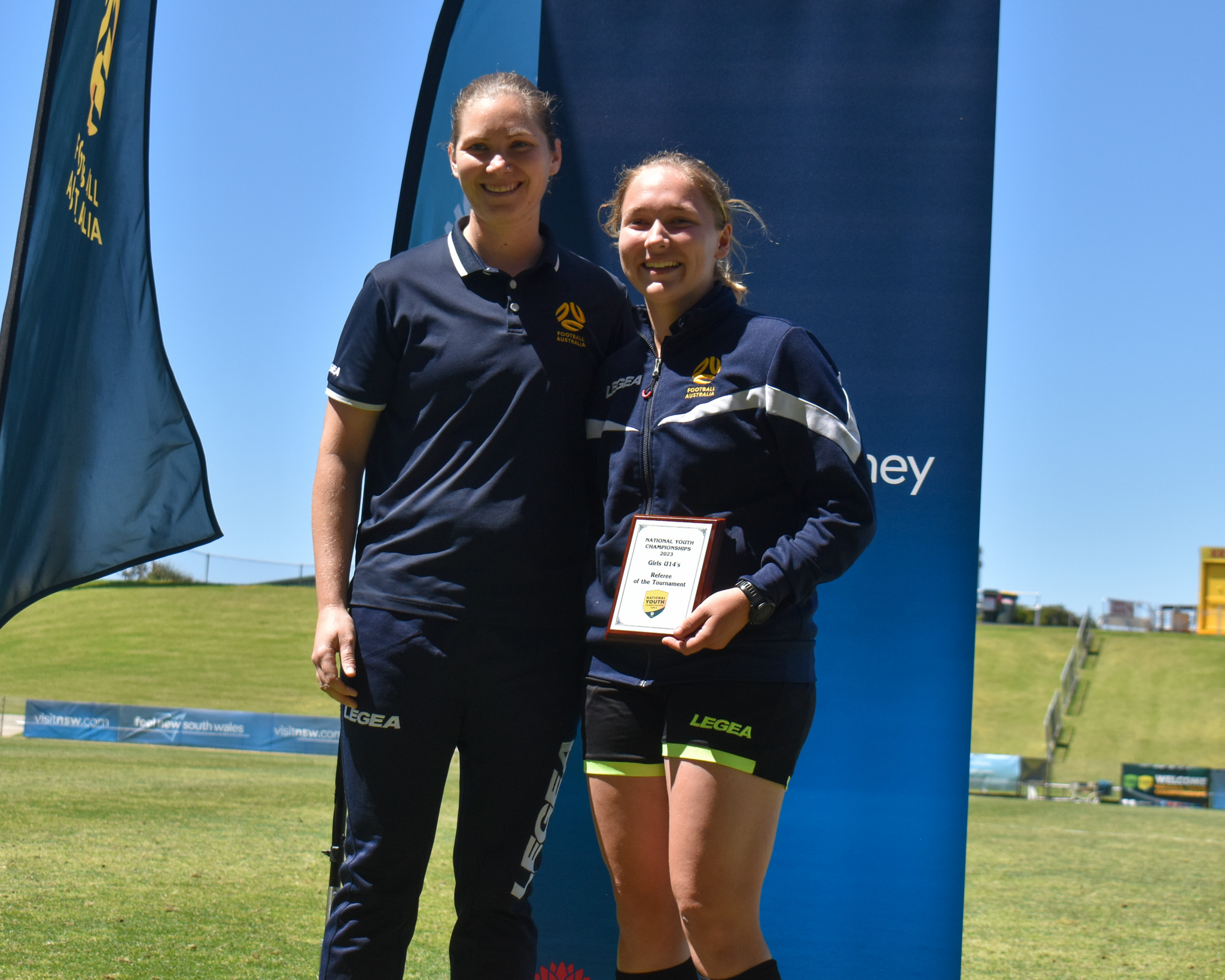 Jessica Jensen receiving the Under 14 Referee of the Tournament from Lead Referee Coach, Danielle Anderson.
